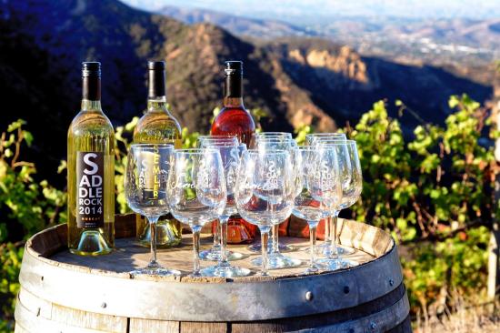 Bottles of wine, with wine glasses